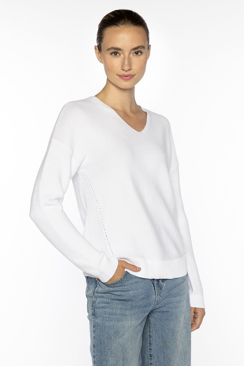 Close-up of the KINROSS CSHMERE Micro Garter Easy Vee Neck Cotton Sweater in Coral, showcasing its premium cotton knit and refined small interlocking stitch pattern—a sophisticated KINROSS addition to any luxury wardrobe.