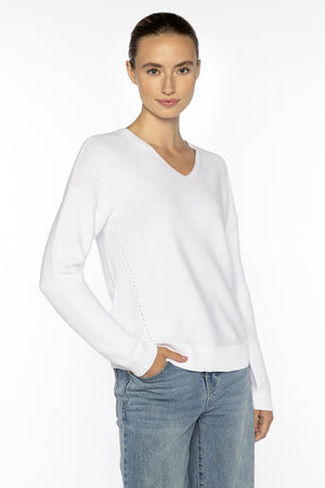 Close-up of the KINROSS CSHMERE Micro Garter Easy Vee Neck Cotton Sweater in Coral, showcasing its premium cotton knit and refined small interlocking stitch pattern—a sophisticated KINROSS addition to any luxury wardrobe.