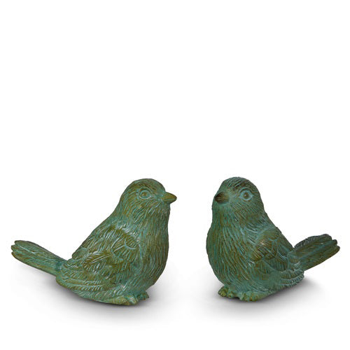 The VERDIGRIS BIRD sculptures by RAZ IMPORTS, crafted from resin with a patina finish, display intricate feather details and are elegantly posed facing each other on a plain white background.