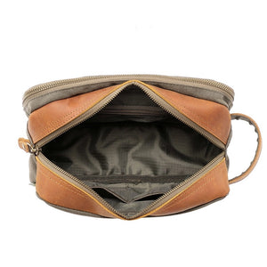 The TSD BRAND Turtle Ridge Toiletry Bag in Olive features leather accents and durable waxed canvas. Grooming essentials fit neatly in elastic loops and mesh pockets, making it the perfect travel companion.