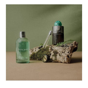 A clear glass spray vial of MOLTON BROWN Wild Mint & Lavandin Eau de Parfum 7.5, featuring a silver nozzle and minimalist label with wild mint and lavandin design.