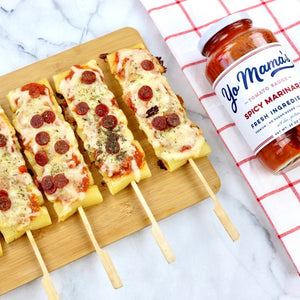 A jar of Yo Mama's Vodka Sauce is shown. The label highlights its fresh ingredients, premium quality, no sugar added, and low-sodium content. KETO Certified and low carb, it has a net weight of 25 oz (708g). "Yo Mama's" is written in large blue script font.