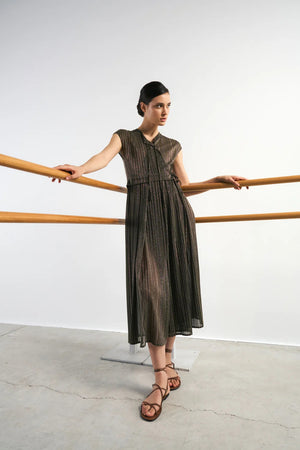 The SANDRO FERRONE - CROSSOVER V NECK DRESS is sleeveless, ankle-length, with metallic pleats, a belted waist, and a V-neckline, shown on a plain light gray background.