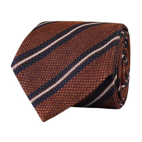 The AMANDA CHRISTENSEN Striped Jacquard Woven Silk Tie in Rust Melange features a sophisticated textured pattern with diagonal navy blue and white stripes, making it an ideal addition to your men’s accessories collection.