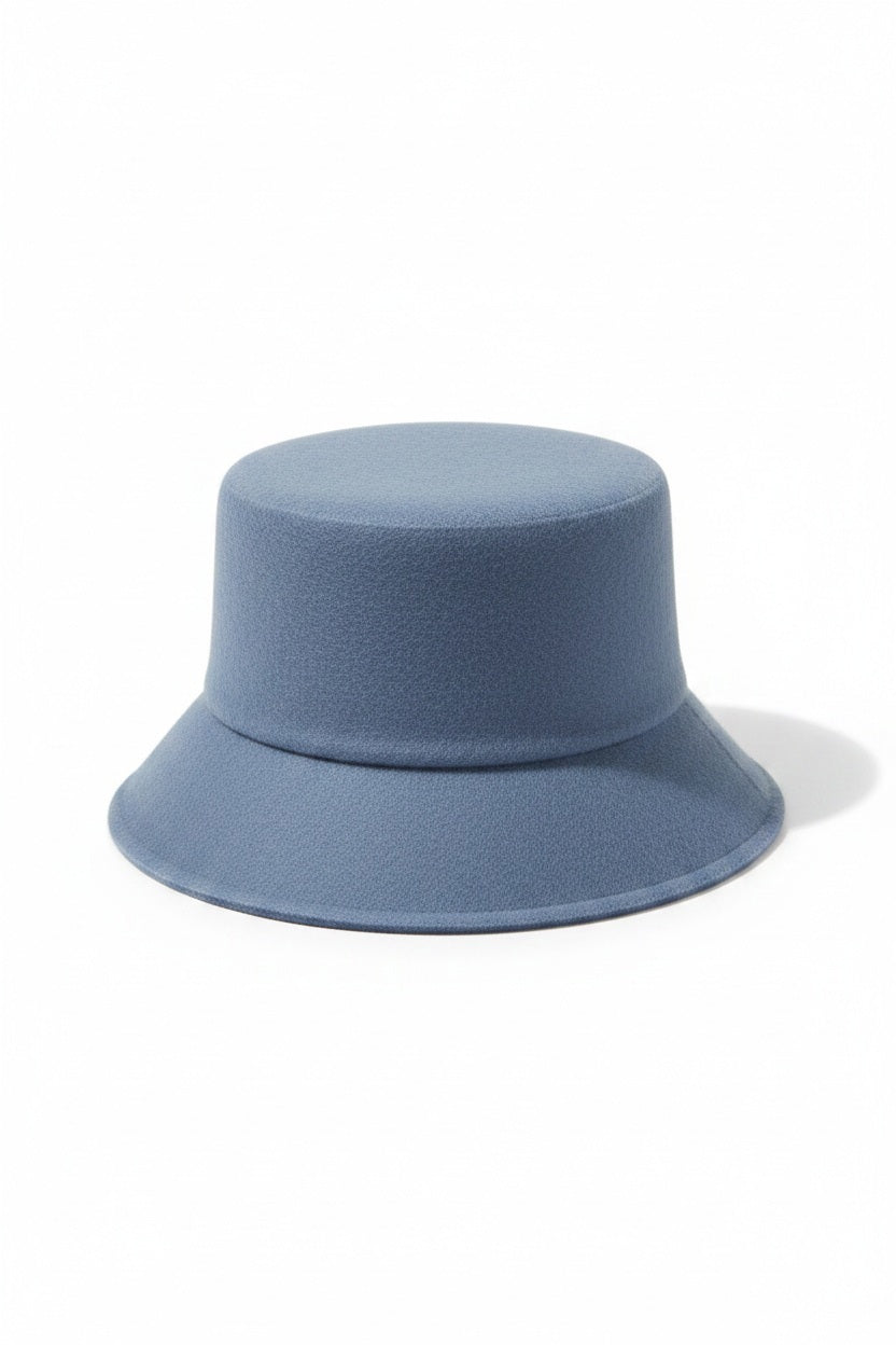 WYETH's TENLEY BUCKET HAT, a blue bucket hat made from fuzzy mohair wool and featuring a wide brim, is presented against a simple white background.