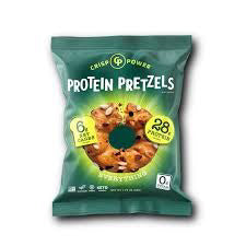 A green bag of CRISP POWER-PROTEIN PRETZEL EVERYTHING by CRISP POWER displays protein pretzels and highlights “28g protein,” “6g net carbs,” and “0g sugar”—a tasty, plant-based, keto-friendly snack.