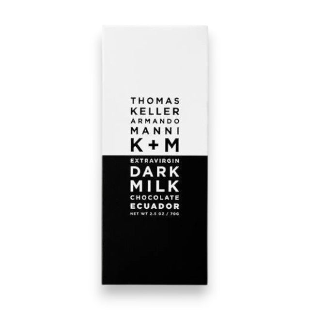 A minimalist black and white wrapper labeled "K+M - EXTRAVIRGIN DARK MILK ECUADOR BAR, K & M EXTRAVIRGIN CHOCOLATE, Net Wt 2.5 oz / 70g.
