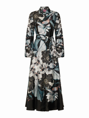 The FRANCO FERRARI ALOE Silk Maxi Shirtdress features long sleeves, an ankle-length cut, a black base with white, teal, and light pink oversized floral print, a collared neckline, and a matching tie belt at the waist.