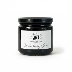 Introducing the FEARRINGTON HOUSEMADE STRAWBERRY JAM from the FEARRINGTON SIGNATURE COLLECTION, this jar of delicious strawberry jam is adorned with a charming black and white striped ribbon tied around the lid. Perfect as a hostess gift, its label lists wholesome ingredients such as strawberry, vanilla, lemon, pectin, and sugar. This handmade treat may contain allergens and is a delightful choice for breakfast jam enthusiasts.