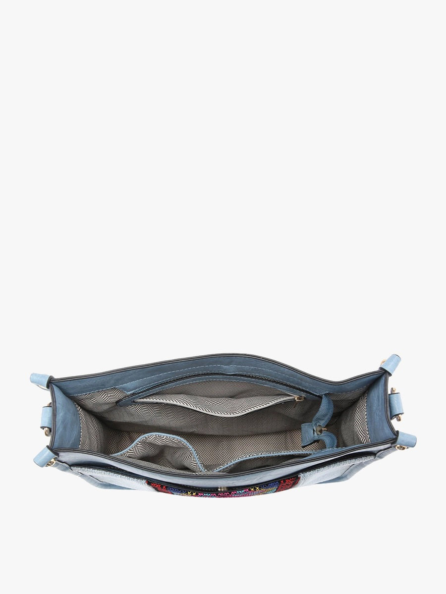 The JEN &amp; CO DENIM CROSSBODY WITH GUITAR STRAP showcases a trendy gray fabric, black trim, adjustable guitar strap, and stylish rectangular shape with rounded corners. It features a front pocket and is set against a plain white background for both style and functionality.