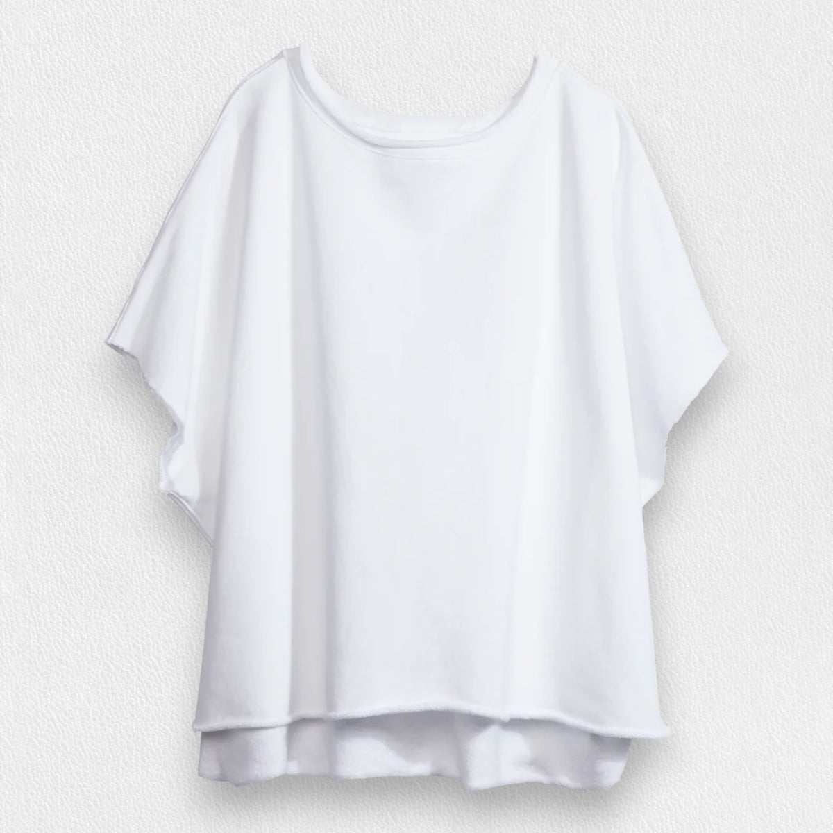 The FRANK &amp; EILEEN Olive Original Capelet in white, a 100% cotton T-shirt with short sleeves and a wide neckline, hangs against a textured light gray background.