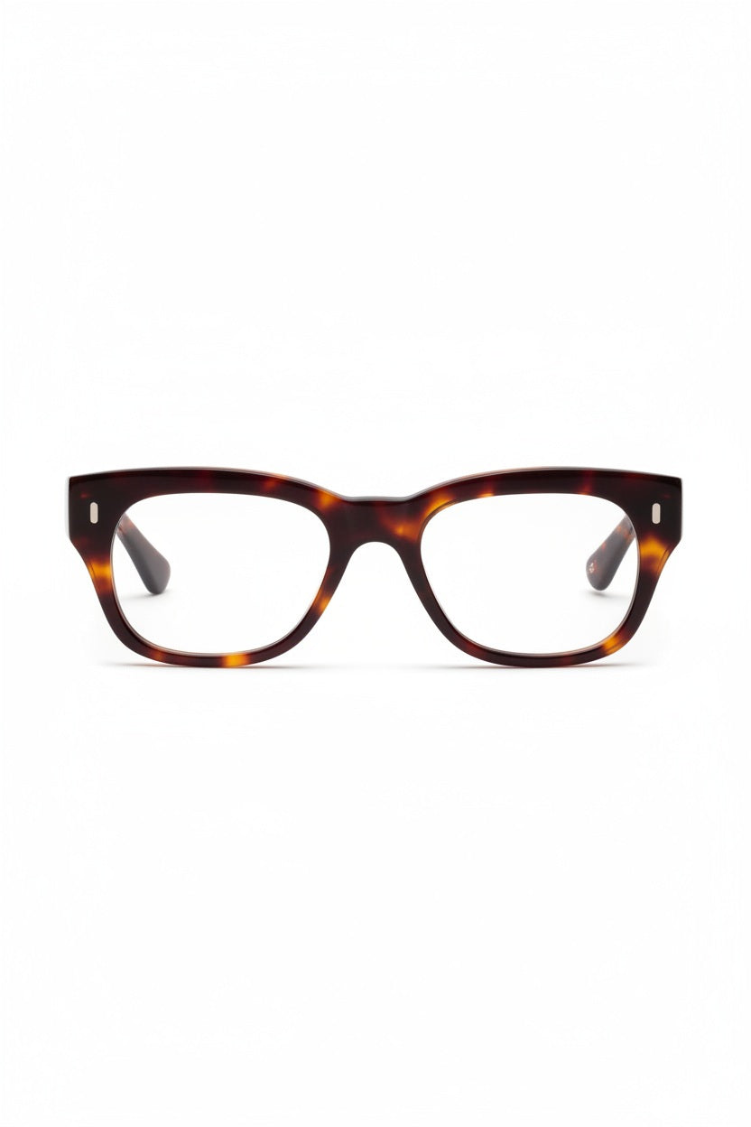The CADDIS - MIKLOS PROGRESSIVE READERS by CADDIS are eyeglasses featuring thick, rectangular tortoiseshell premium acetate frames with clear lenses, displayed against a white background.