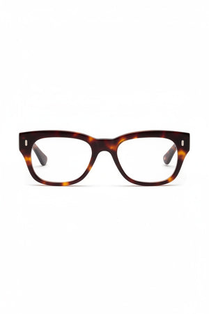 The CADDIS - MIKLOS PROGRESSIVE READERS by CADDIS are eyeglasses featuring thick, rectangular tortoiseshell premium acetate frames with clear lenses, displayed against a white background.