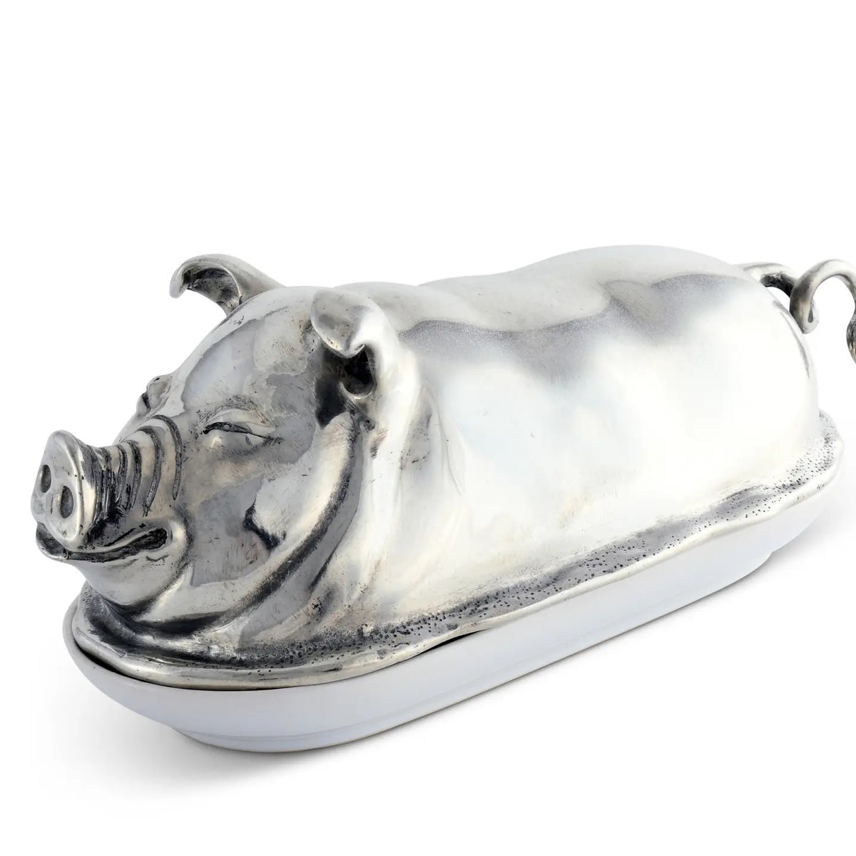 The VAGABOND HOUSE Pewter Happy Pig Butter Dish, a luxury-grade piece by VAGABOND HOUSE, gleams beside a white plate with butter and two slices, its lid open against a pristine white backdrop.