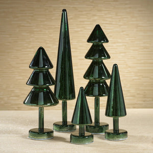 The ZODAX NOEL SPARKLE SPRUCE LED TREE is a tall, dark green, cone-shaped glass sculpture with LED lights, standing upright on a circular base and featuring a modern, abstract tree design.