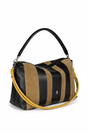 The CRAIE STUDIO HALO STRIPE NOIR SEPIA handbag features black and tan vertical stripes, a black handle, a yellow knotted shoulder strap, and a subtle silver logo on the front. Expertly crafted from grained leather by CRAIE STUDIO, this bag showcases a modern, structured silhouette that enhances its sophisticated allure.