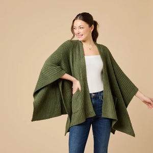 A woman wearing a black SOFTIES - SOLID RIB MARSHMALLOW SHAWL over a grey top and white trousers.