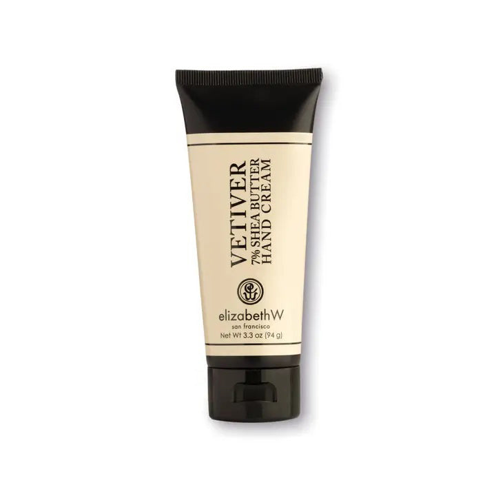 A beige and black tube of the hydrating VETIVER HAND CREAM 3.3OZ by E WIGHTMAN &amp; CO. The packaging displays 3.3 fl oz (98 g) on the front with the E WIGHTMAN &amp; CO logo and branding. The shea butter hand cream tube has a black cap at the bottom.