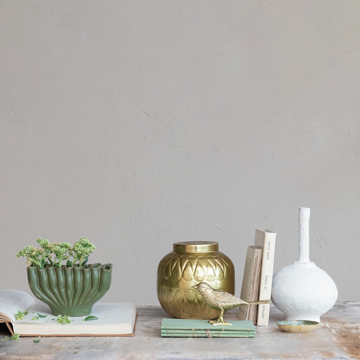 The CREATIVE COOP STONEWARE SCULPTURAL VASE WITH 9 SECTIONS is a matte green vase with a wavy, ridged design and uneven rim, measuring 4.75" tall by 8" wide—an eye-catching modern accent for your décor.