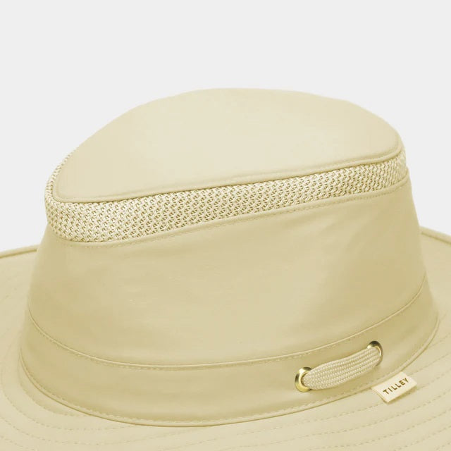 The TILLEY AIRFLO Broad Brim Hat LTM6 in Khaki Olive features mesh ventilation around the crown for outdoor use. Shown on a plain light background, this wide-brimmed sun protection hat is crafted by TILLEY.