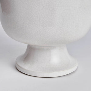 A photograph of the NAPA HOME AND GARDEN - ALBIE FOOTED CACHEPOT, a traditional white ceramic pedestal bowl with a textured, crackled finish. It features a smooth, glossy surface on a wide base, perfect for enhancing any home decor as a centerpiece.