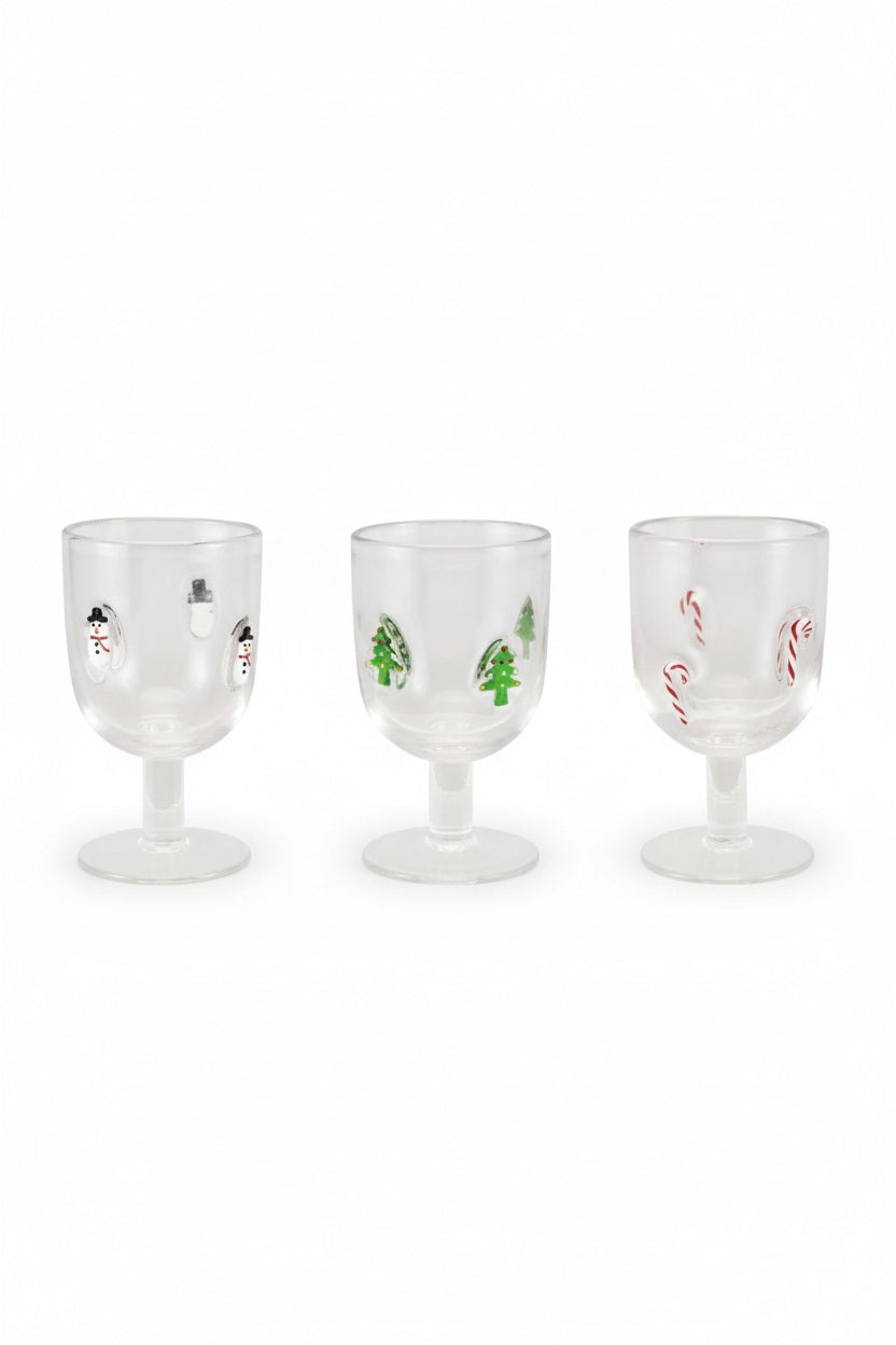 Three STEMMED WINE GLASS WITH EMBEDDED HOLIDAY ICONS, each a clear stemmed glass decorated with whimsical hand-painted icons of snowmen, Christmas trees, and candy canes.