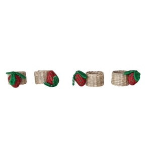 The CREATIVE COOP HAND-WOVEN SEAGRASS STRAWBERRY NAPKIN RINGS, SET OF 4, feature red and green strawberry accents and are displayed on a white background.