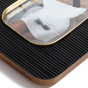The ZODAX Black Resin Ribbed Photo Frame with Brass Accent (4x6) is shown from the back, featuring a rectangular support stand and two metal clasps securing the rear panel.