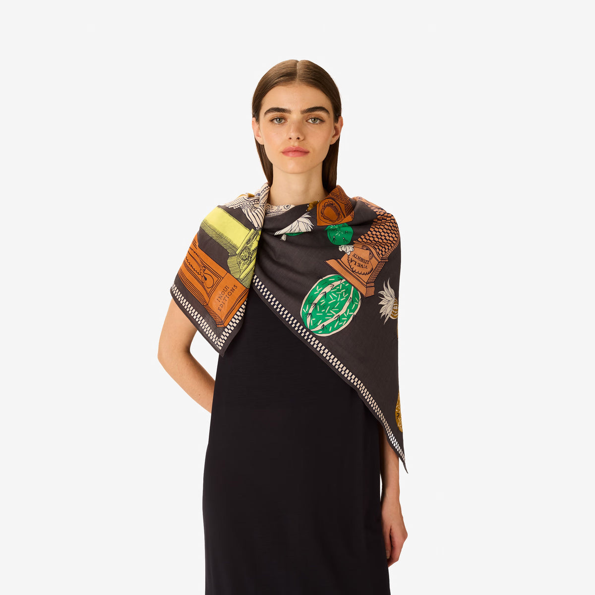 The INOUI EDITIONS - TEQUILA SCARF IN LEMON by INOUI features vibrant cacti and succulents in green, yellow, and white on brown and gray pedestals, set against a dark gray background with a decorative border.