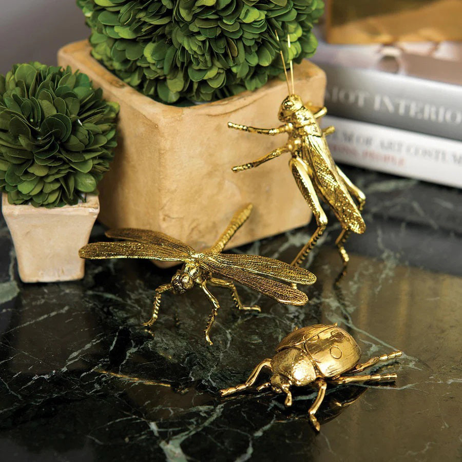 The ZODAX DECORATIVE GOLD LADYBUG is a small gold-colored figurine with detailed legs and body, measuring 2.75 x 2.5 x 1 inches, shown on a plain white background.