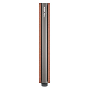 A slim, rectangular SECRID Slimwallet Texano in Saddle stands vertically, featuring a metallic finish with wooden sides. The brand name “SECRID” is printed in white near the top, exemplifying a blend of style and RFID protection for your essentials.