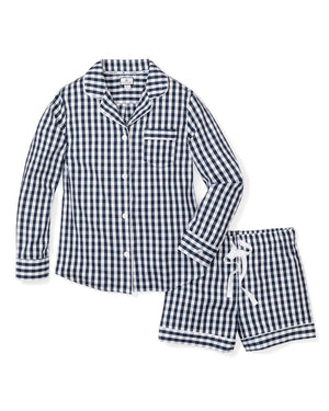 Introducing the FEARRINGTON LIFESTYLE COLLECTION - WOMEN'S TWILL PAJAMA SET IN NAVY FRENCH TICKING by PETITE PLUME. This set features a collared, long-sleeve shirt with a front pocket and button closures, paired with matching pants that have a drawstring waistband. Both pieces are adorned in a classic white and light blue striped pattern.