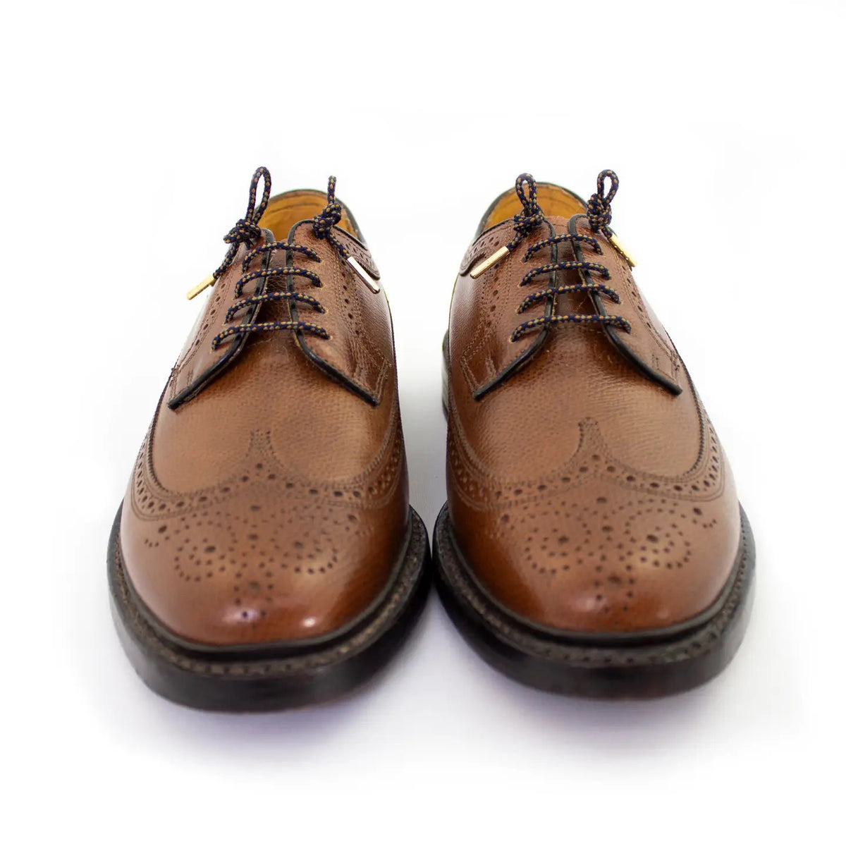 A pair of STOLEN RICHES DRESS SHOELACES IN OXFORD, premium nylon laces in blue and orange with gold tips, coiled and wrapped in a white "Stolen Riches - Since 1915" band noting "Made in Canada" and "56 inches.