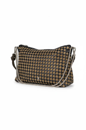 The CRAIE STUDIO - MALLOW TRESSE SEPIA NOIR HANDBAG is a checkered brown and black intrecciato bag featuring a knotted strap, displayed on a white pedestal against a plain white background. This crossbody design from CRAIE STUDIO highlights the artistry of braided leather handbags in a timeless silhouette.