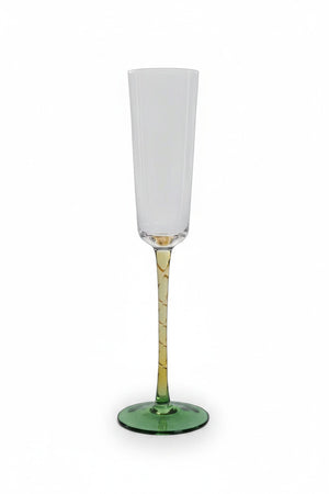 A VICENZA GREEN AND AMBER CHAMPAGNE FLUTE by Zodax featuring a clear soda-lime glass bowl, a textured amber stem, and a green glass base.