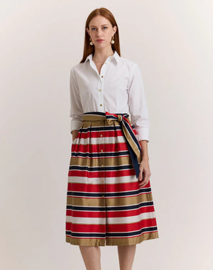 A woman stands against a plain background wearing the HINSON WU ROBIN 3/4 Sleeve Dress in Nautical Stripe, featuring red, navy, white, and tan stripes. Made from a luxurious, machine-washable cotton blend satin.