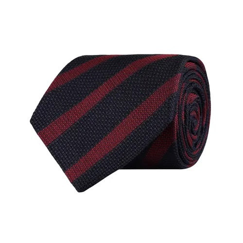 The AMANDA CHRISTENSEN Striped Jacquard Woven Silk Tie in wine red, a men’s formal accessory by AMANDA CHRISTENSEN, features diagonal black and dark red stripes and is displayed rolled up on a white background.