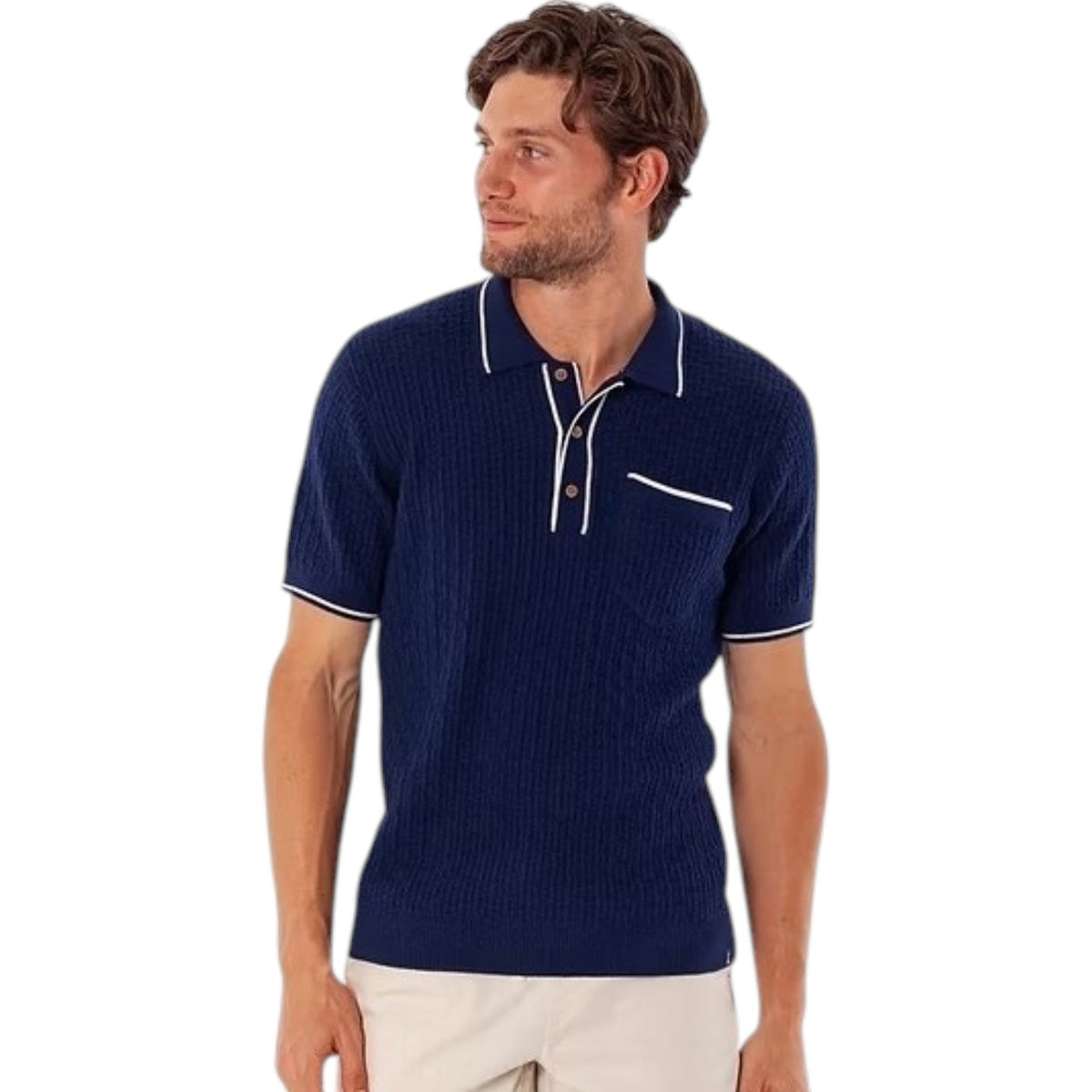 A man models the CRIQUET Bungalow Sweater Polo in navy, featuring white trim on the collar, sleeve cuffs, buttons, and pocket, against a plain white background.