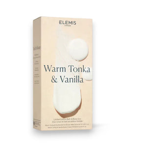 A beige box with the ELEMIS - STEINER logo at the top and "Warm Tonka & Vanilla" written below in large text. The bottom of the box mentions "Limited Edition Body Duo." The box features an abstract white paint design in the background, evoking a touch of British wilderness.