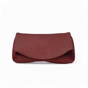 OLIVEVE Valentina Clutch in Barolo Italian buffalo cowhide, a dark red clutch featuring a curved fold-over flap.