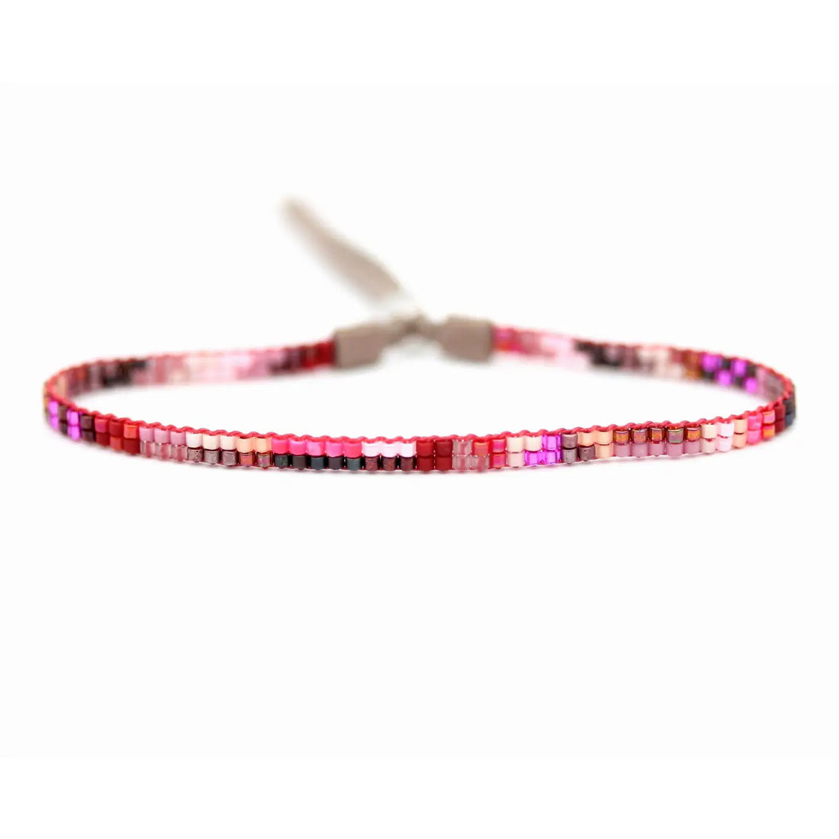 The JULIE ROFMAN - MINI BRACELET by JULIE ROFMAN JEWELRY is a vibrant handwoven piece adorned with small, square beads in various shades of pink, red, and white. It is displayed against a white background and includes a straightforward sterling silver clasp for convenient fastening.