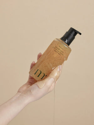 A Molovany Hypoallergenic LHA C18 Gel Cleanser bottle from Hong Cheon USA, Inc. features a black pump, light brown gel with darker specks for pore and dead skin cell reduction, and a label with black text.