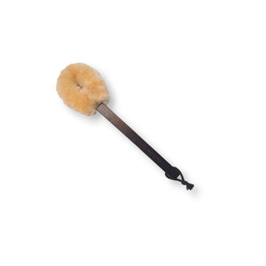 A beige BAUDELAIRE Beechwood 14" Sisal Dry Brush with a dark brown handle rests in an open rectangular box adorned with floral patterns. The box lid, leaning against the box, features the brand name "BAUDELAIRE" and highlights the brush's exceptional beechwood craftsmanship and natural elegance. Ideal for your self-care routine, this brush is made from all-natural sisal fibers.