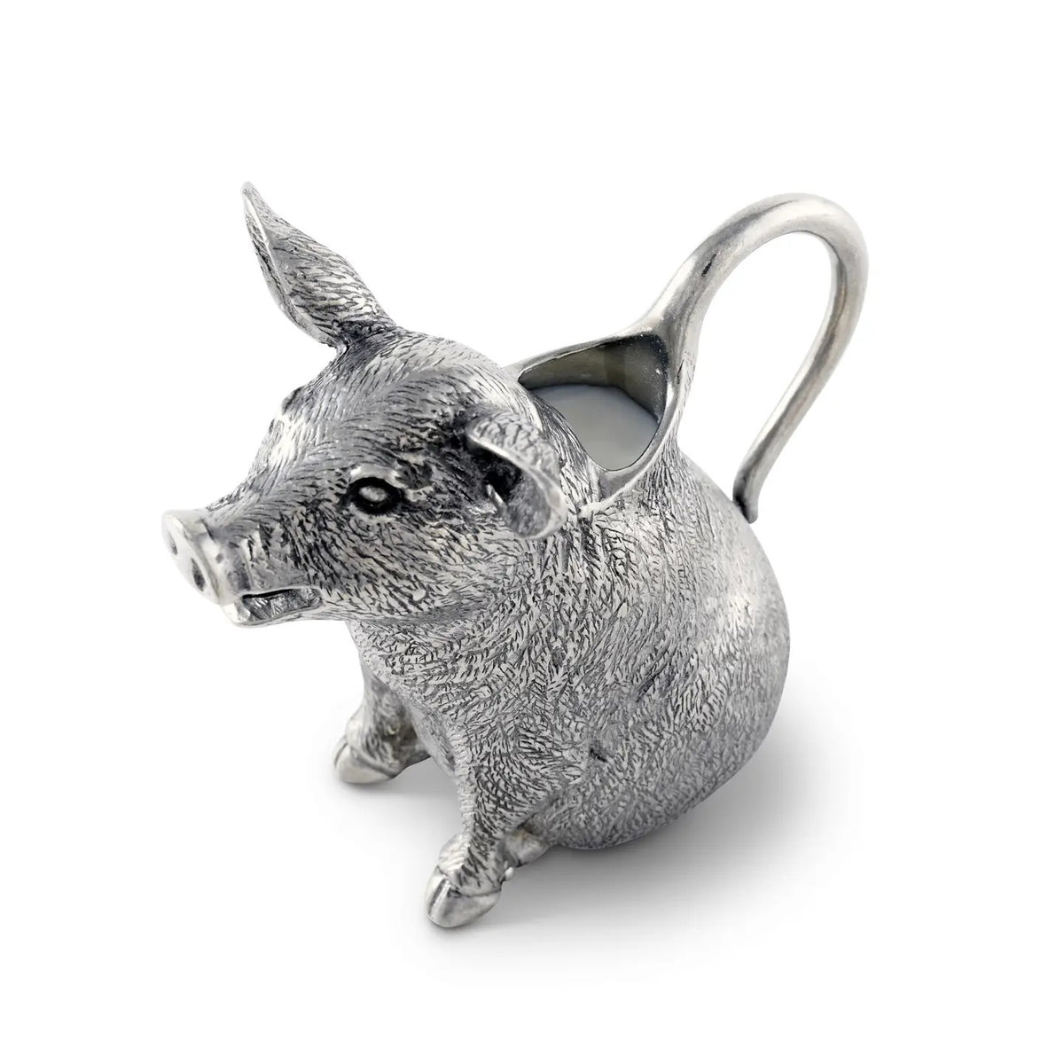The VAGABOND HOUSE - PEWTER HAPPY PIG CREAMER, made from luxury-grade pewter, features pointed ears and detailed design. Its handle stretches from the back, revealing milk inside. This elegant piece by VAGABOND HOUSE sits on a plain white background.