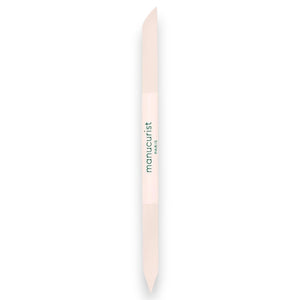 A light pink, double-ended MANUCURIST - GLASS CUTICLE PUSHER with “manucurist PARIS” printed in green at the center, displayed on a white background—an essential reusable nail tool from MANUCURIST INC for any manicure routine.