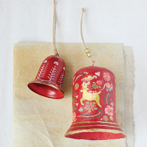 The LARGE PAPER MACHE BELL WITH DEER AND FLORALS by CREATIVE COOP is a red, bell-shaped ornament featuring gold floral patterns, a top gold bead, and hangs from a thin string against a white background.