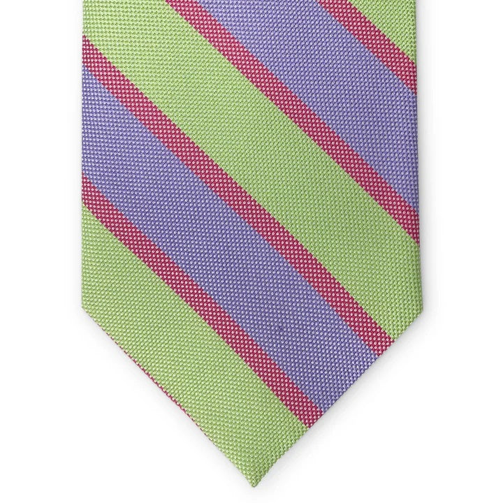 The PETER-BLAIR - BEAUFORT WOVEN SILK TIE IN GREEN by BIRD DOG BAY features diagonal green and lavender stripes separated by thin pink lines, shown rolled up on a white background.