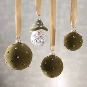 ZODAX SANTA WITH MUSHROOM HAT GLASS ORNAMENT featuring Santa Claus wearing a spotted green mushroom cap, measuring 3.25 x 5 inches.