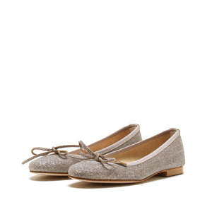 A pair of MICHELE LOPRIORE - MIA BALLET FLAT shoes by MICHELE LOPRIORE, featuring glittery silver leather with small bows on the front, displayed against a plain white background. Made in Italy, these shoes boast a low heel and a sleek, shiny texture.