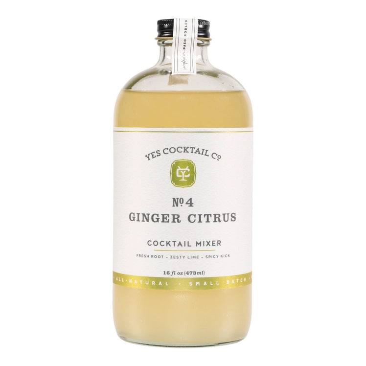 A clear glass bottle with a black cap containing Yes Cocktail Co.'s Ginger Citrus Cocktail Mixer is adorned with a white label featuring green accents. The text indicates it is crafted from fresh root, zesty lime, and has a spicy kick. The bottle holds 16 fl oz (473 ml).